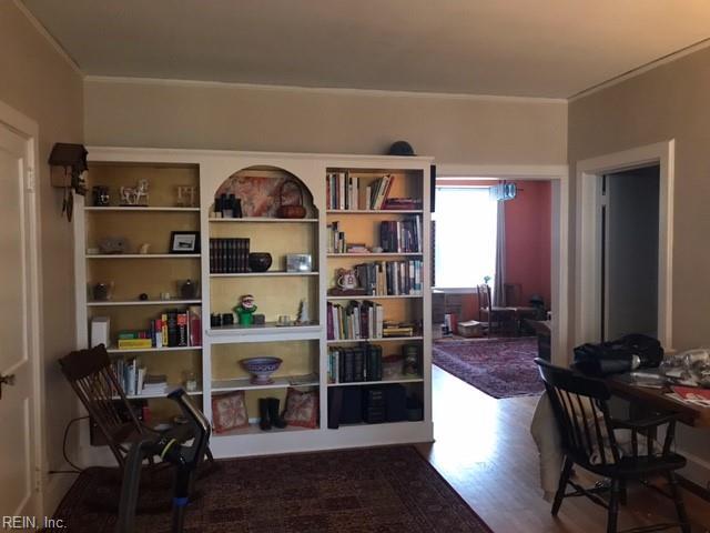 interior space with ornamental molding and wood-type flooring