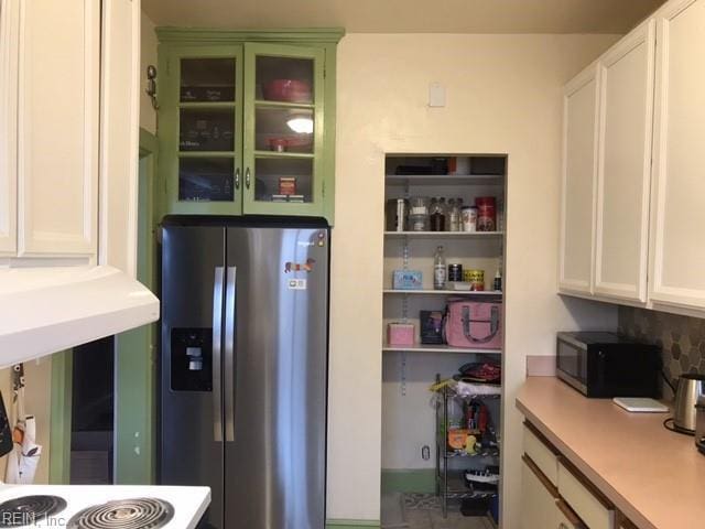 kitchen with white cabinetry and appliances with stainless steel finishes