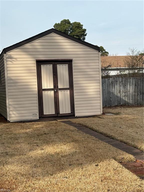 view of outbuilding with a lawn