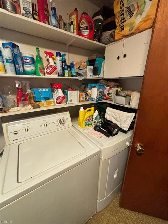 washroom with cabinets and washer and dryer