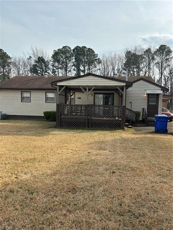 back of property featuring a yard and covered porch