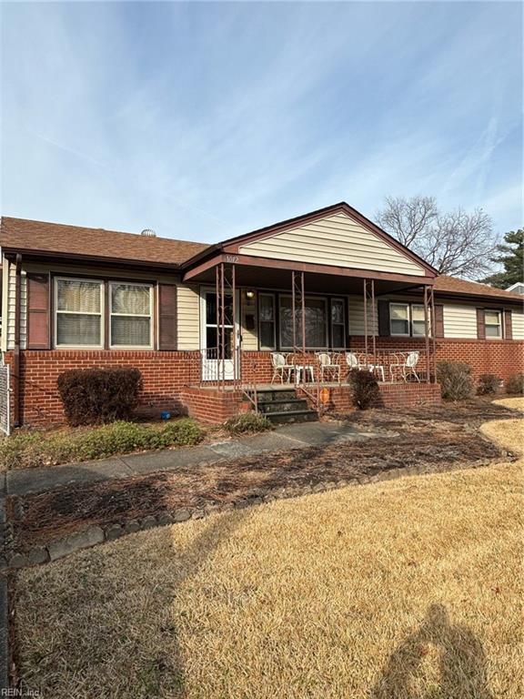 view of front of home featuring a front yard and a porch