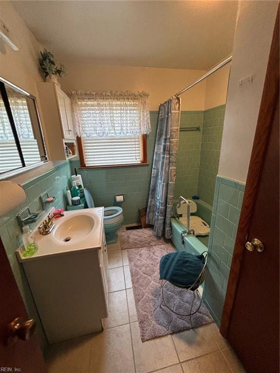 full bathroom with tile patterned floors, toilet, tile walls, and vanity