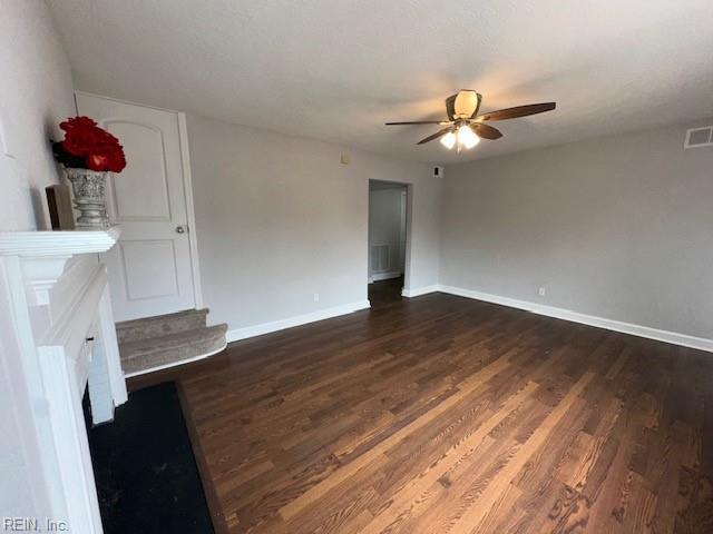 spare room featuring dark hardwood / wood-style floors and ceiling fan