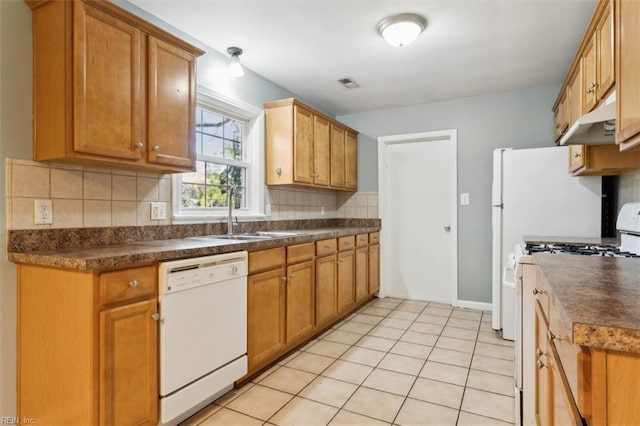 kitchen featuring light tile patterned flooring, sink, backsplash, and white appliances