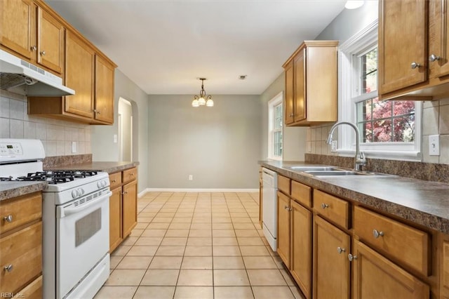 kitchen with sink, white appliances, backsplash, light tile patterned flooring, and decorative light fixtures