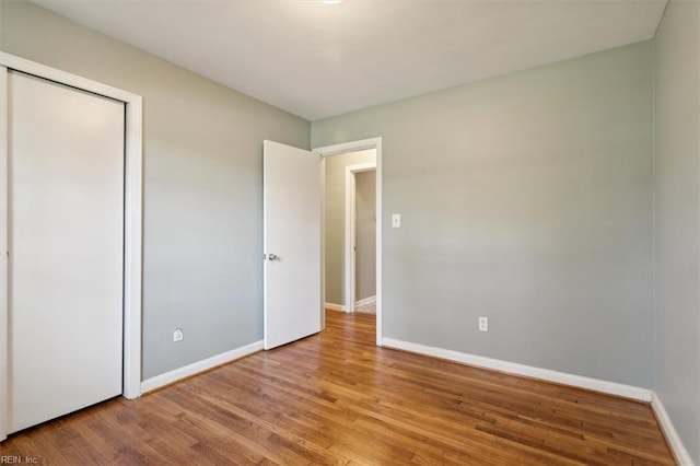 unfurnished bedroom featuring a closet and light wood-type flooring