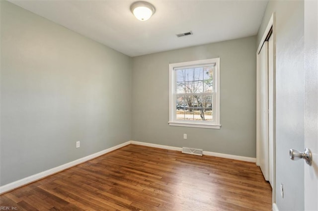 empty room featuring hardwood / wood-style flooring