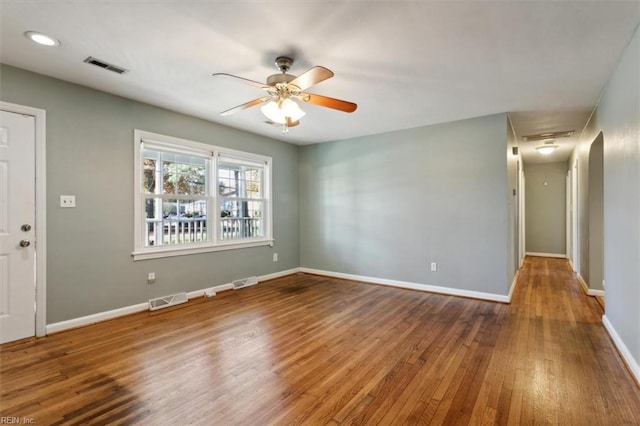 empty room featuring hardwood / wood-style floors and ceiling fan