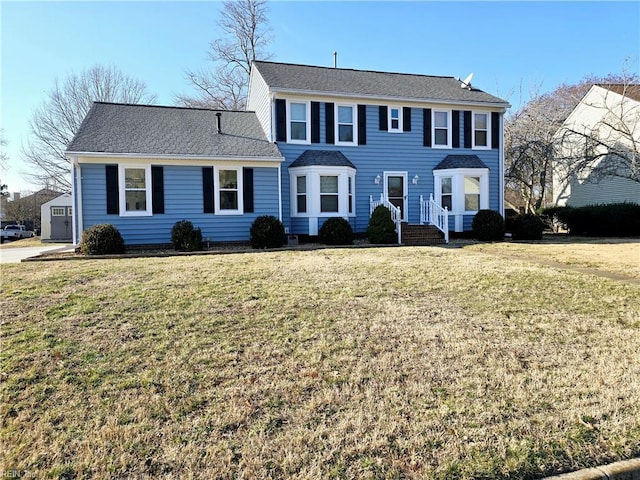 colonial inspired home featuring a front lawn