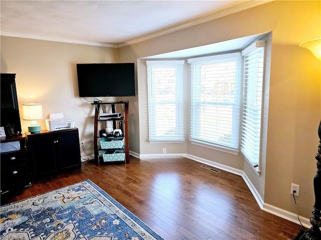 interior space with dark wood-type flooring and ornamental molding