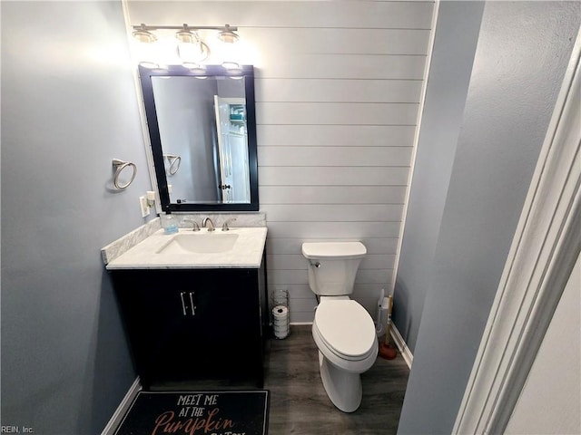 bathroom featuring vanity, toilet, and hardwood / wood-style floors