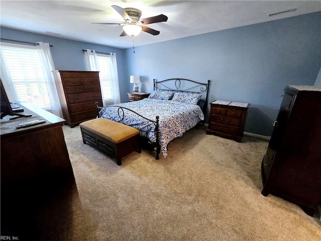 bedroom with ceiling fan and light carpet