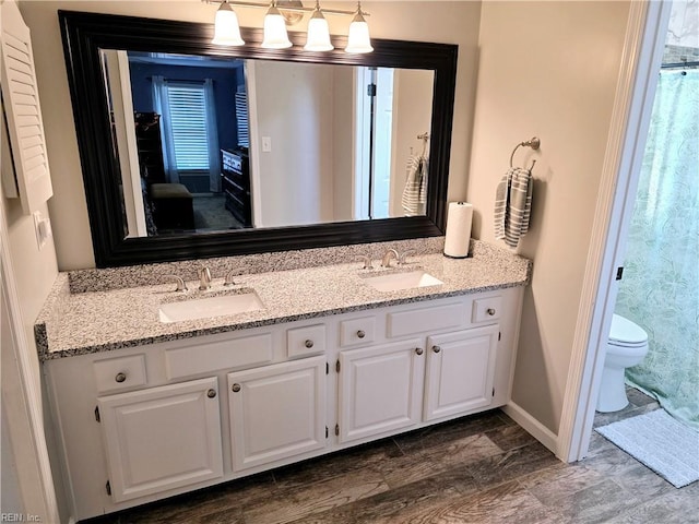 bathroom featuring vanity and toilet