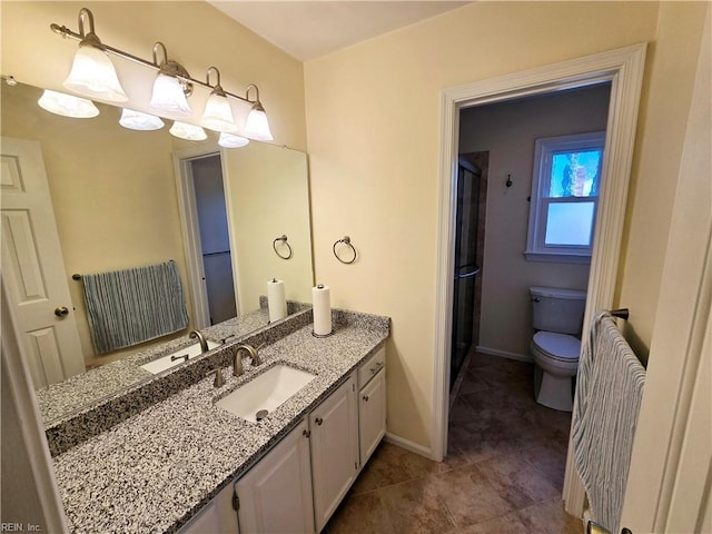 bathroom with vanity, toilet, and a shower with shower door