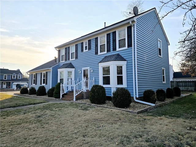 colonial-style house with a lawn