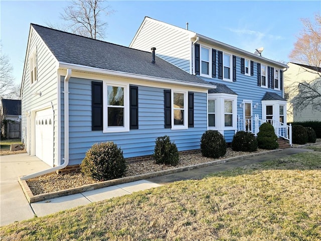 view of front of property featuring a garage and a front lawn