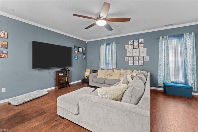 living room with dark wood-type flooring, ornamental molding, and ceiling fan