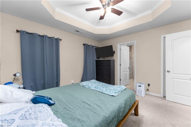 bedroom with a raised ceiling, ornamental molding, light carpet, and ceiling fan