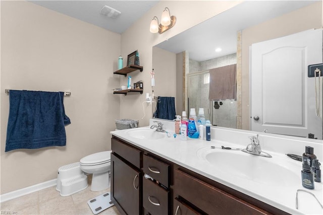 bathroom featuring a shower with door, vanity, tile patterned floors, and toilet