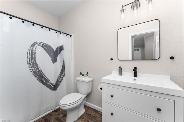 bathroom featuring vanity, toilet, and hardwood / wood-style floors