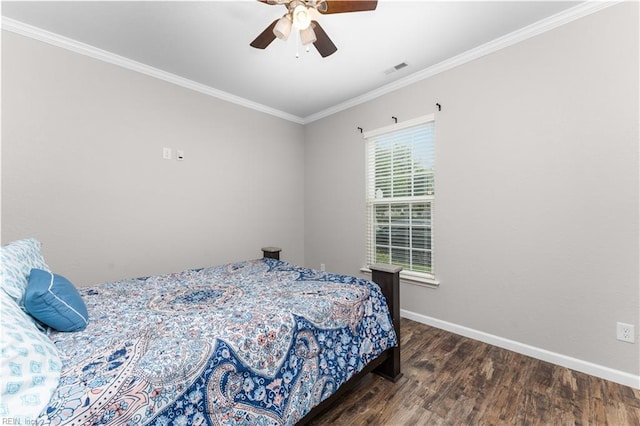 bedroom featuring dark wood-type flooring, ceiling fan, and crown molding