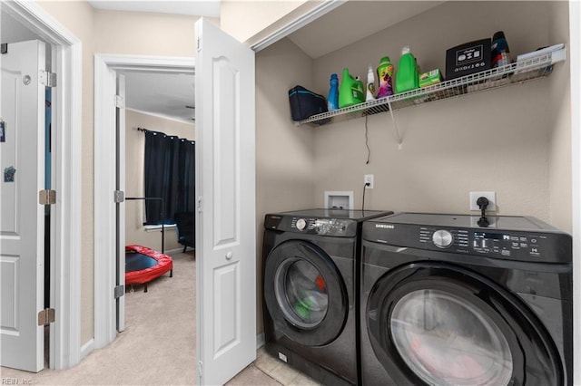 laundry room with light colored carpet and washing machine and dryer