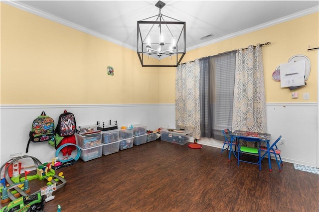 rec room featuring ornamental molding, hardwood / wood-style floors, and a notable chandelier