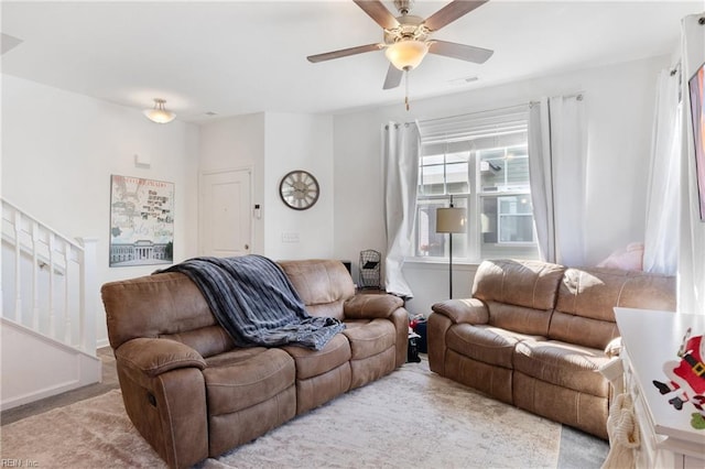 carpeted living room featuring ceiling fan