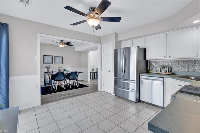 kitchen featuring light tile patterned floors, sink, white cabinetry, backsplash, and stainless steel appliances