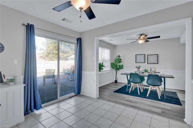 dining space with light wood-type flooring and ceiling fan