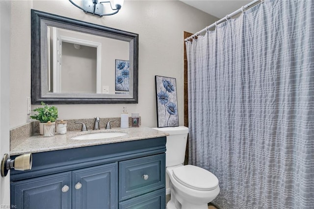 bathroom featuring vanity, a shower with shower curtain, and toilet