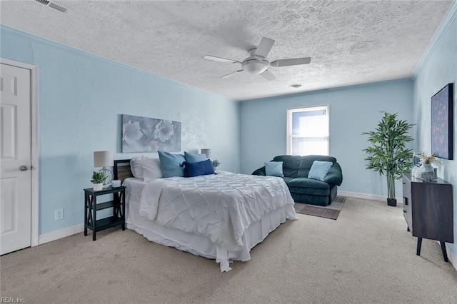 carpeted bedroom featuring ceiling fan, crown molding, and a textured ceiling