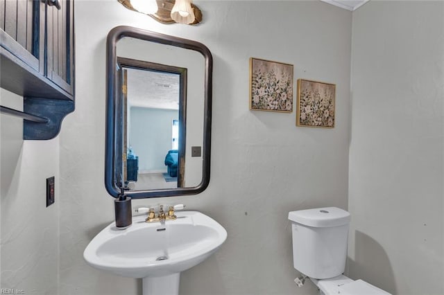 bathroom featuring sink and toilet