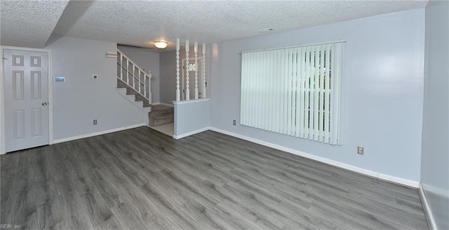 interior space with a textured ceiling and dark hardwood / wood-style flooring