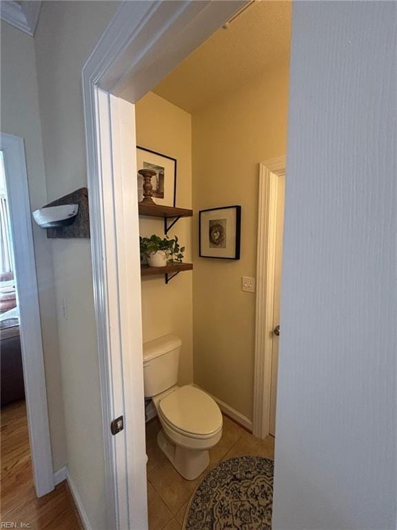 bathroom featuring tile patterned flooring and toilet