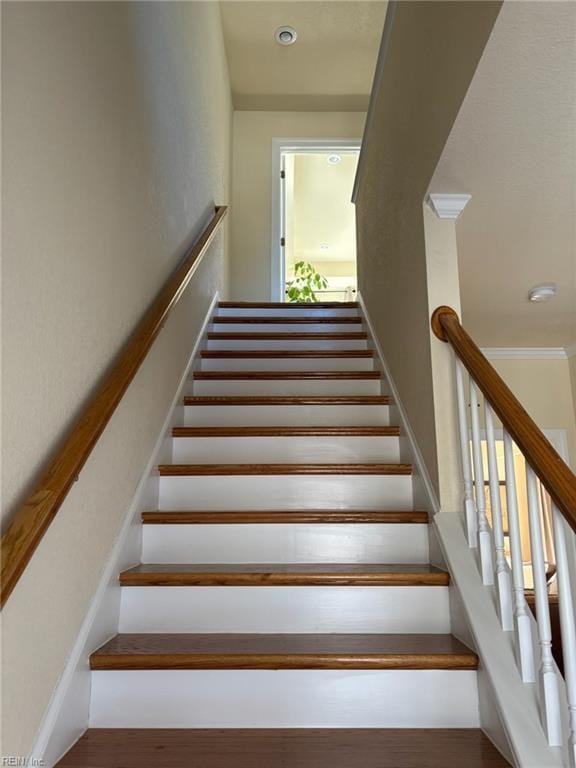 staircase with ornamental molding