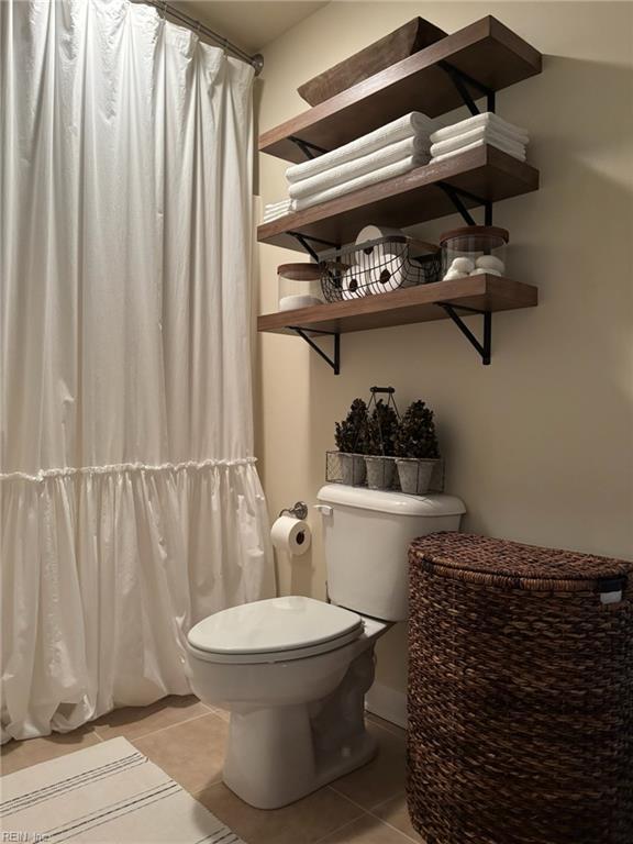 bathroom featuring tile patterned floors and toilet