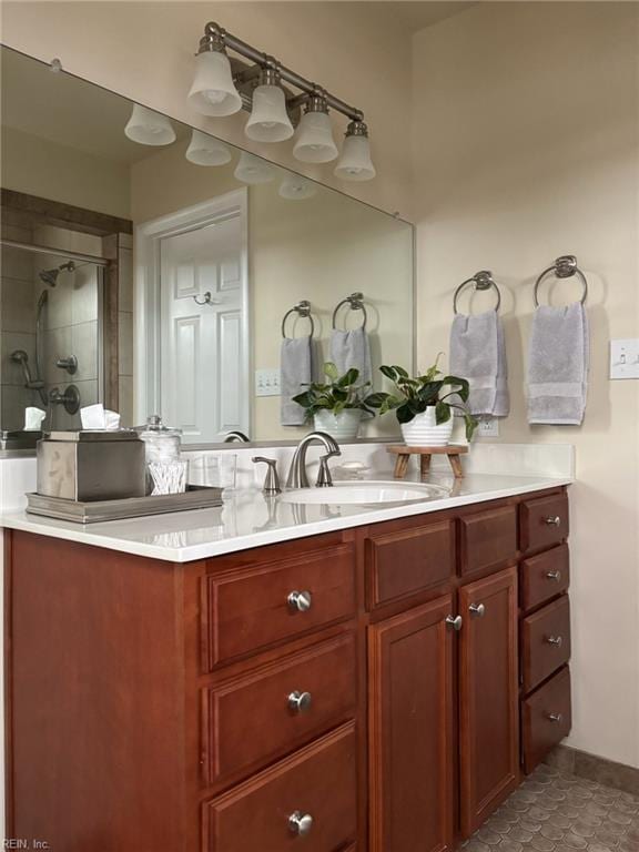 bathroom with vanity and a tile shower