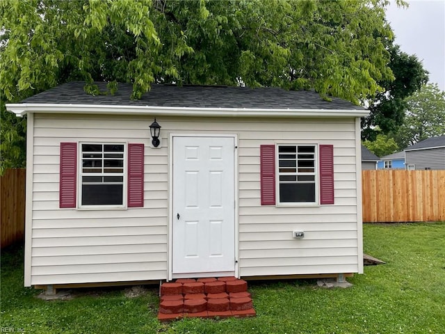 view of outdoor structure featuring a lawn