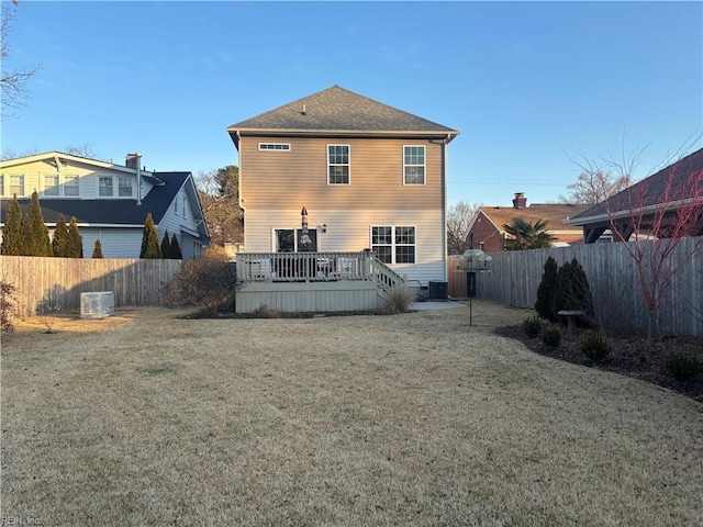 rear view of house featuring a yard, central air condition unit, and a deck