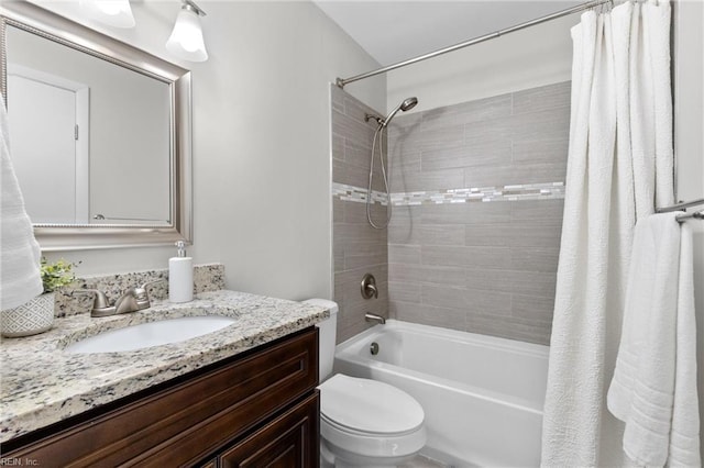 full bathroom with shower / bathtub combination with curtain, vanity, and toilet