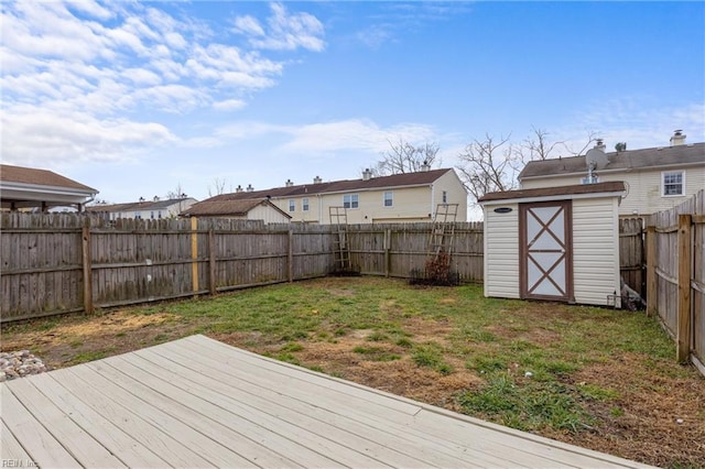 wooden deck featuring a yard and a shed