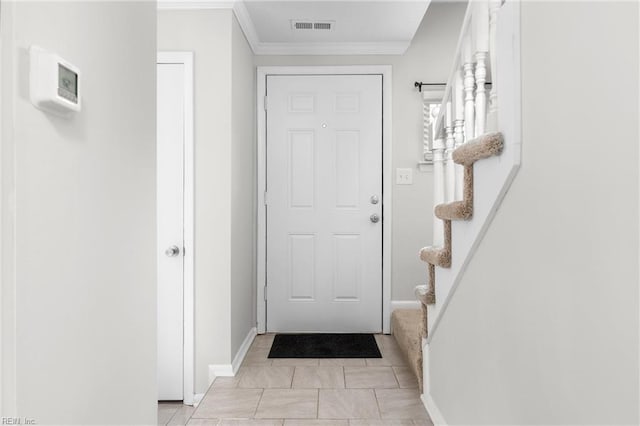 doorway featuring ornamental molding and light tile patterned floors