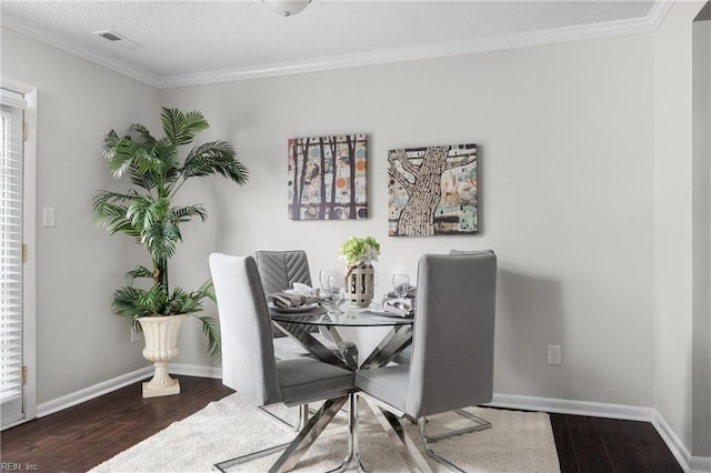 dining space with crown molding and hardwood / wood-style floors