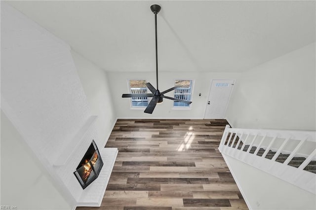 living room featuring dark hardwood / wood-style flooring and a brick fireplace