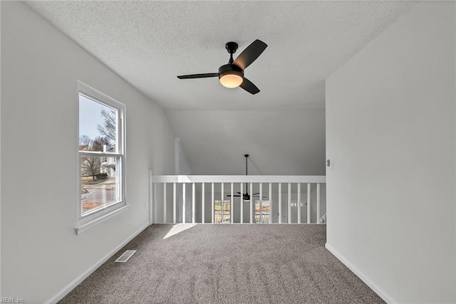 bonus room with vaulted ceiling, ceiling fan, carpet floors, and a textured ceiling