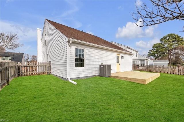 back of house featuring cooling unit, a yard, and a patio area