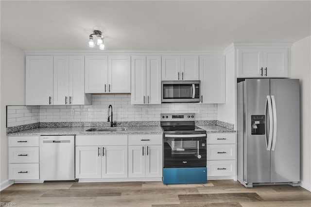 kitchen featuring stainless steel appliances, sink, and white cabinets