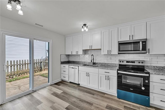 kitchen with sink, stainless steel appliances, and white cabinets